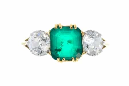 An-early-20th-century-18ct-gold-emerald-and-diamond-three-stone-ring-£2400