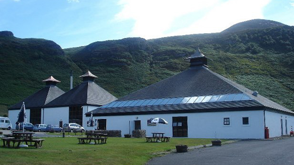 The exterior of Arran distillery with picnic tables