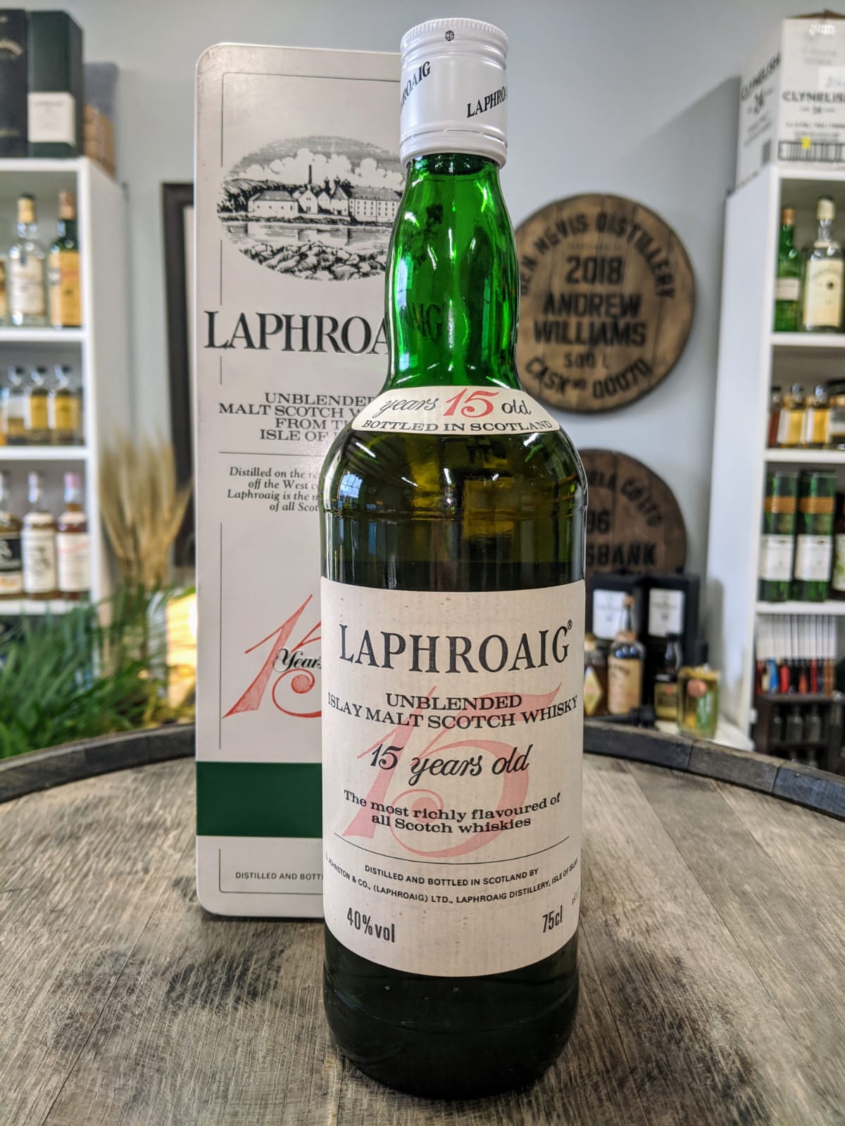 A Laphroaig bottle from the 1990s with red cursive lettering.