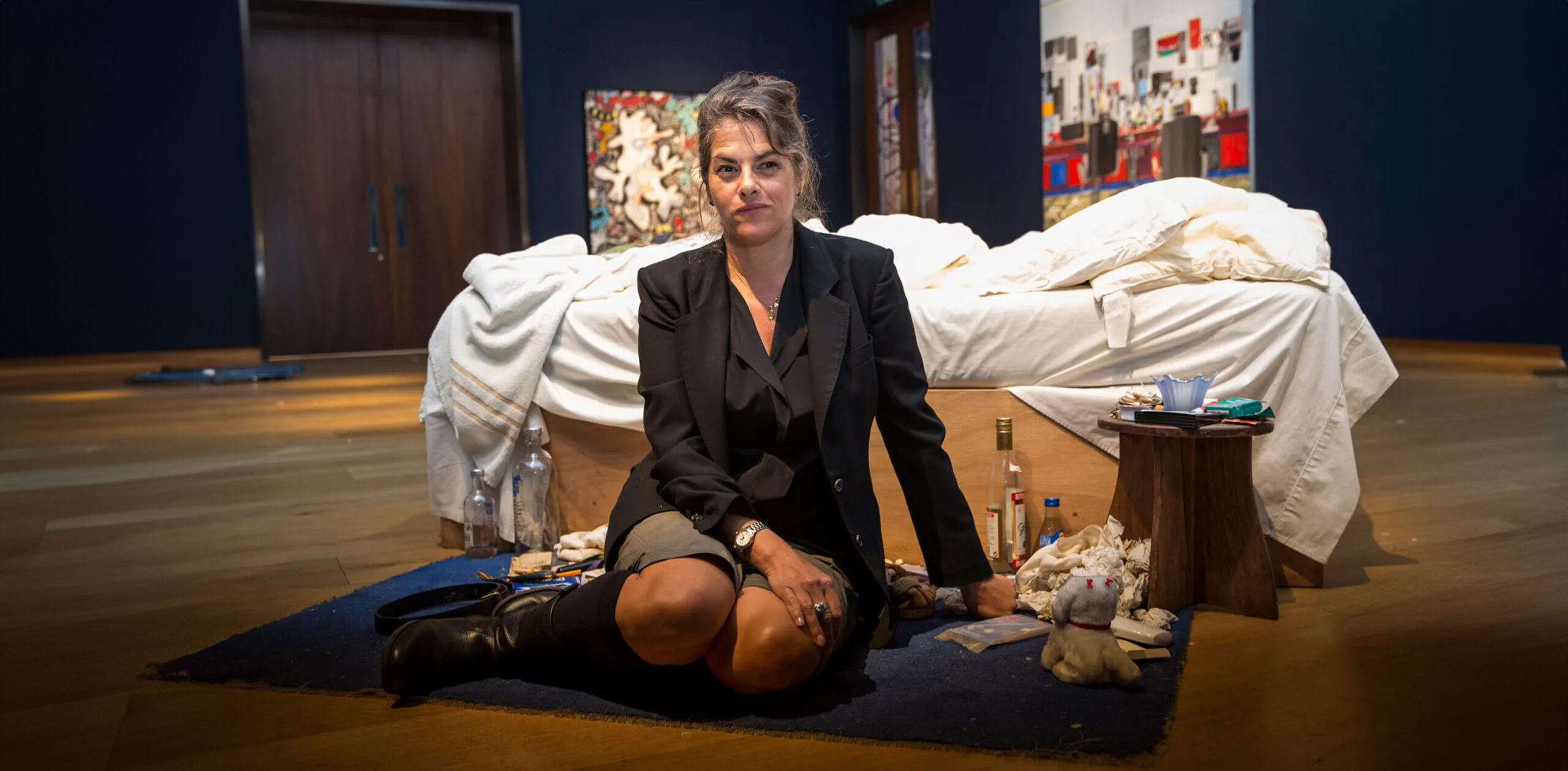 Tracey Emin sitting in front of ‘My Bed,’ the installation piece that earned her a Turner Prize nomination.