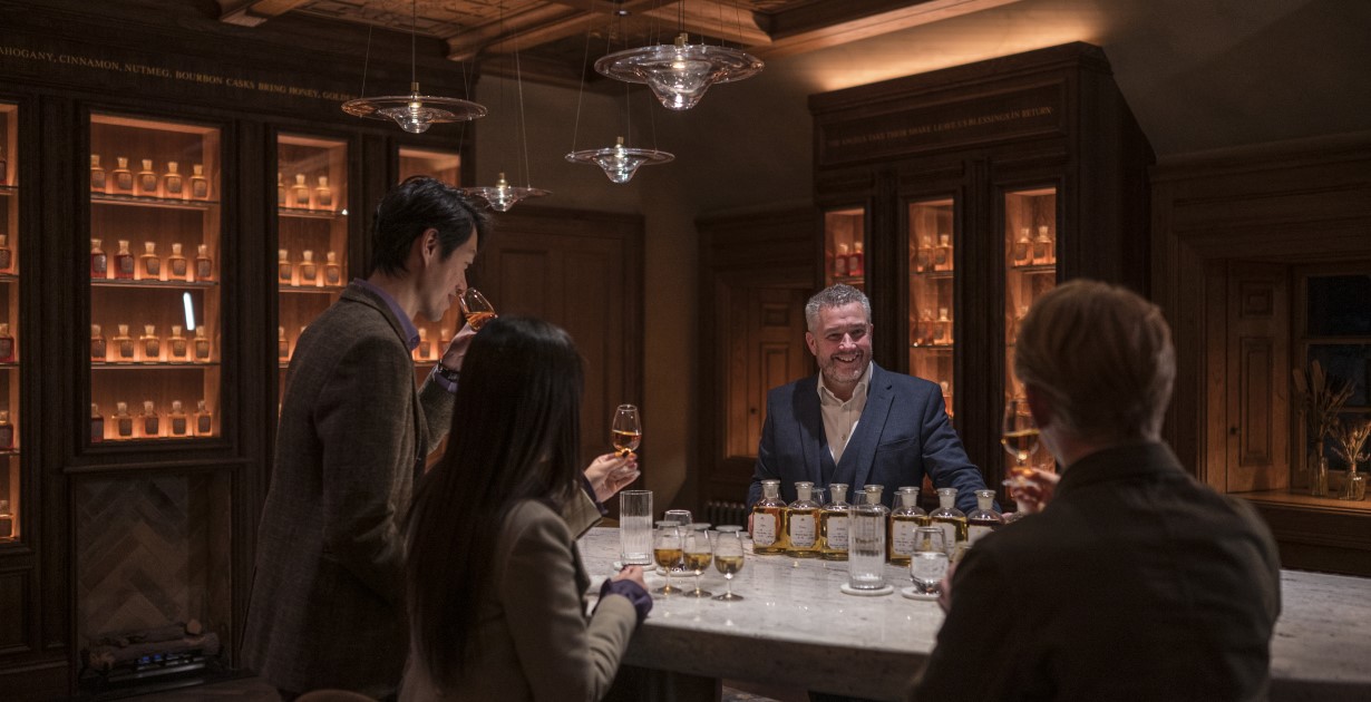 3 people sample whisky under guidance at The Chivas Vault