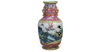 A Qianlong Imperial Carved Porcelain Hollowed and Turned Vase with Phoenix Pattern and a Carmine Ground, Qing dynasty
